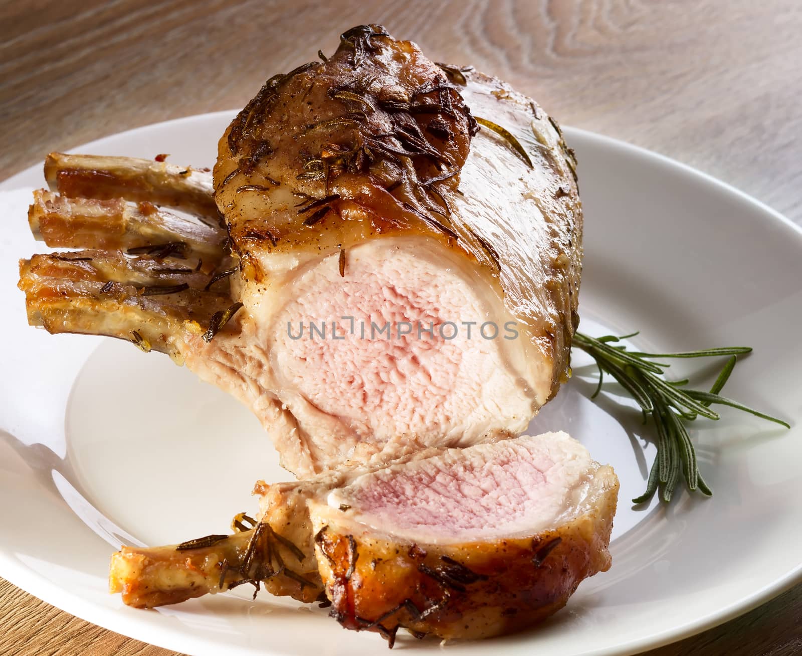 Grilled meat with rosemasy on white plate
