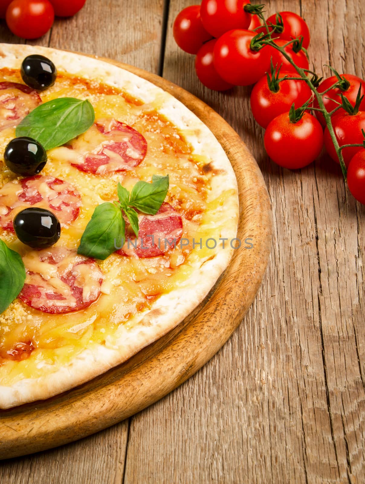 Close up view of pizza with salami, olives and basil