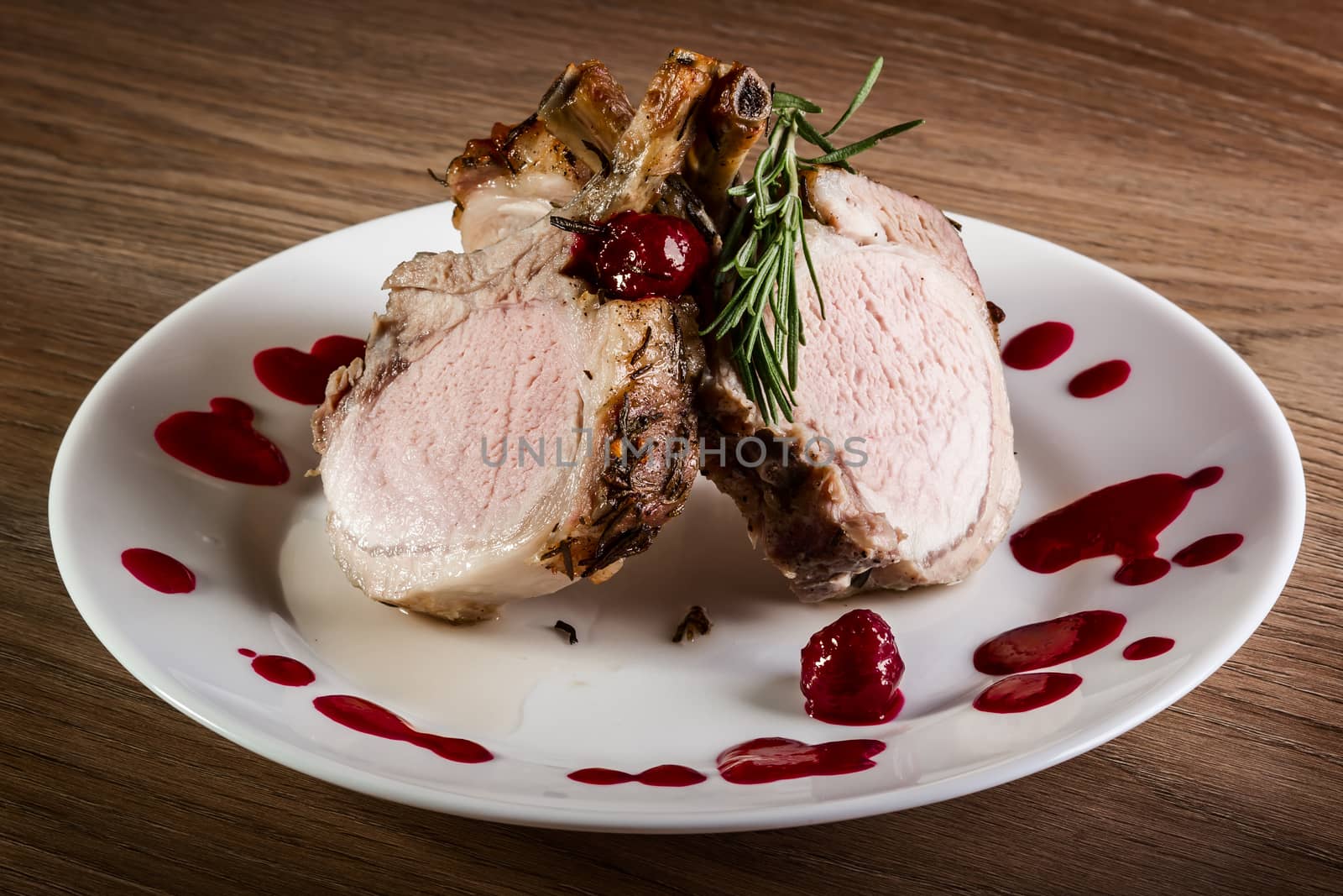 Meat with fruit sauce on white plate