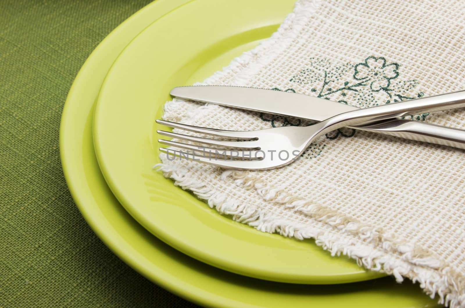 Green plates with fork and knife