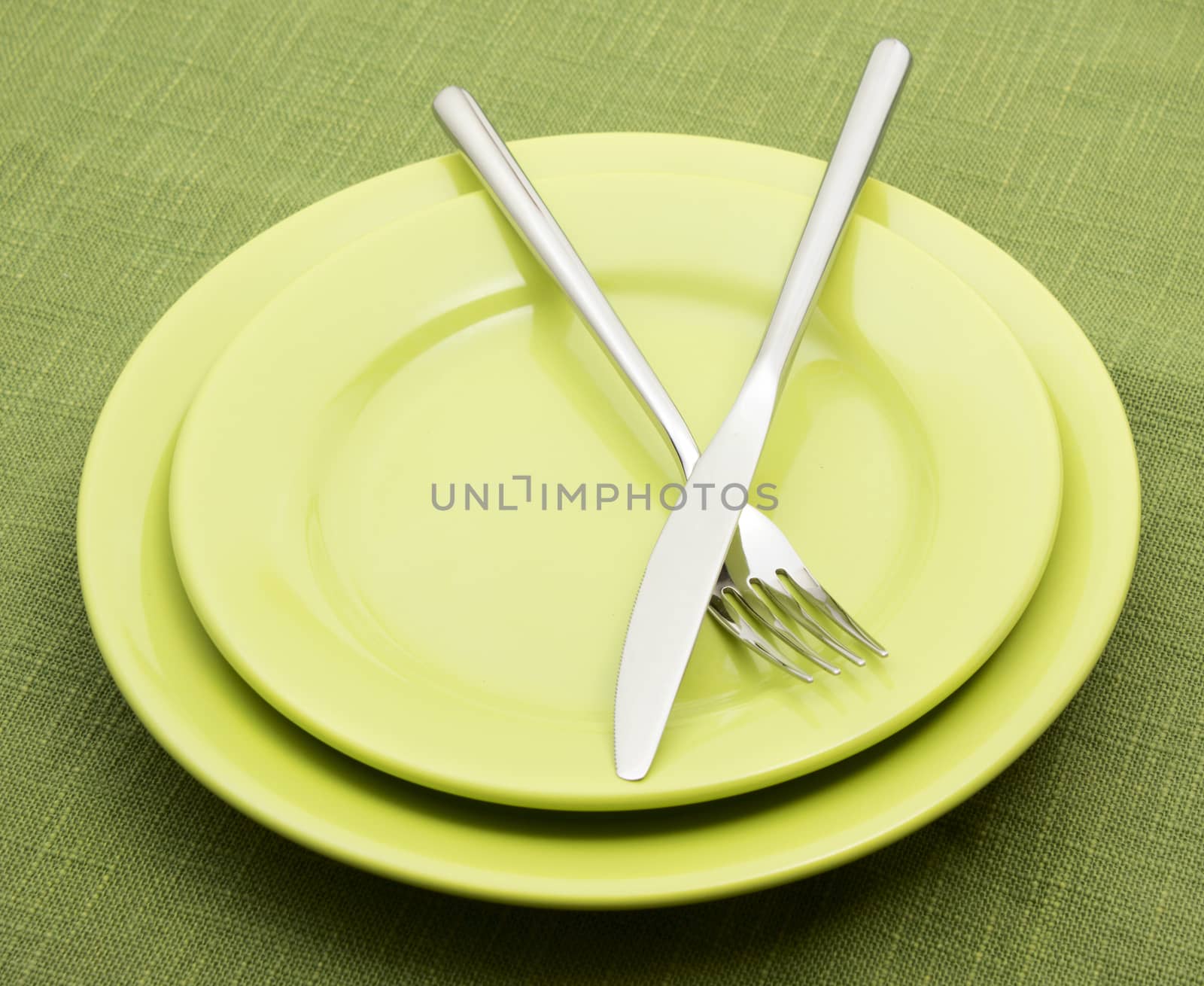 Green plates with fork and knife