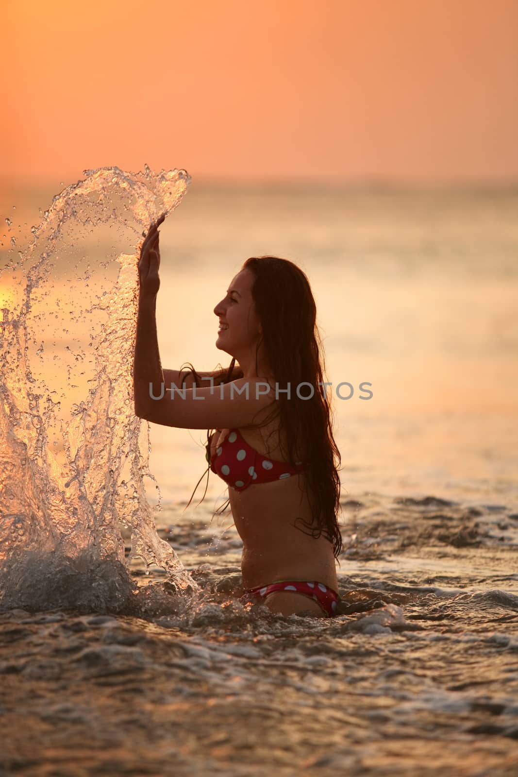 Silhouette of the beautiful girl in ocean