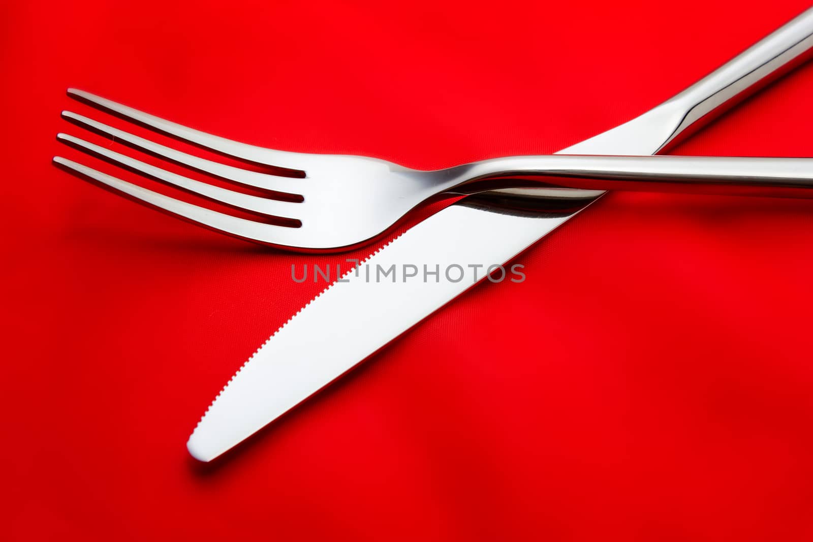 Fork and knife on red tablecloth