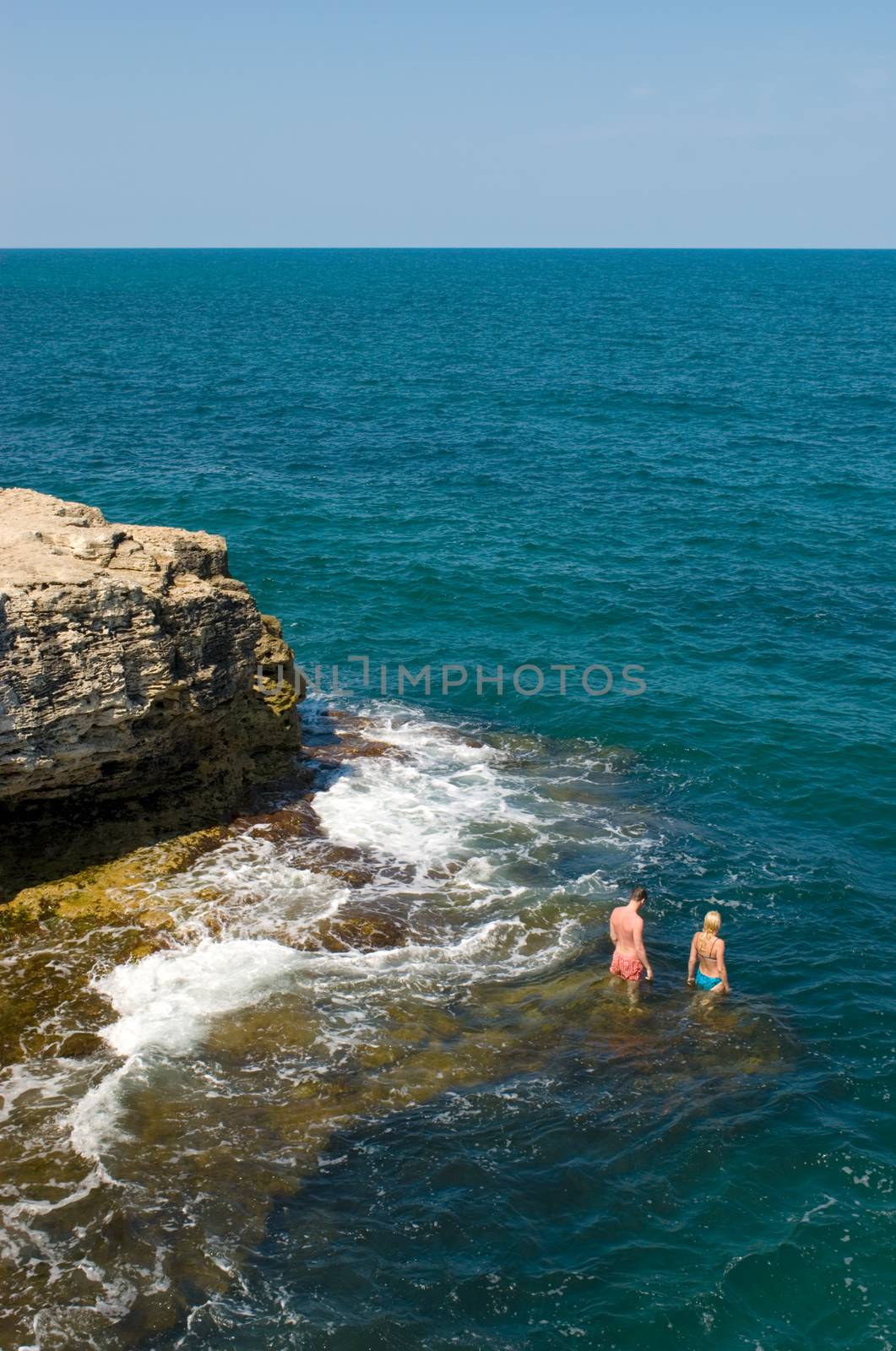 Crimea, the Black Sea and the good weather. Man and woman are going to bathe.