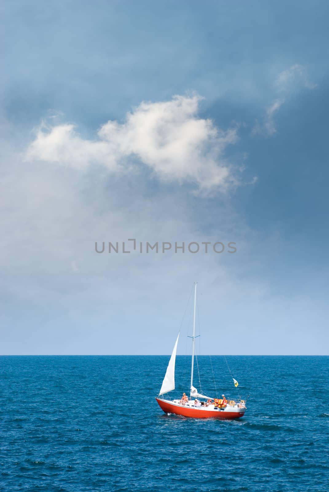 Crimea, the Black Sea. A lone sailboat, and storm clouds.