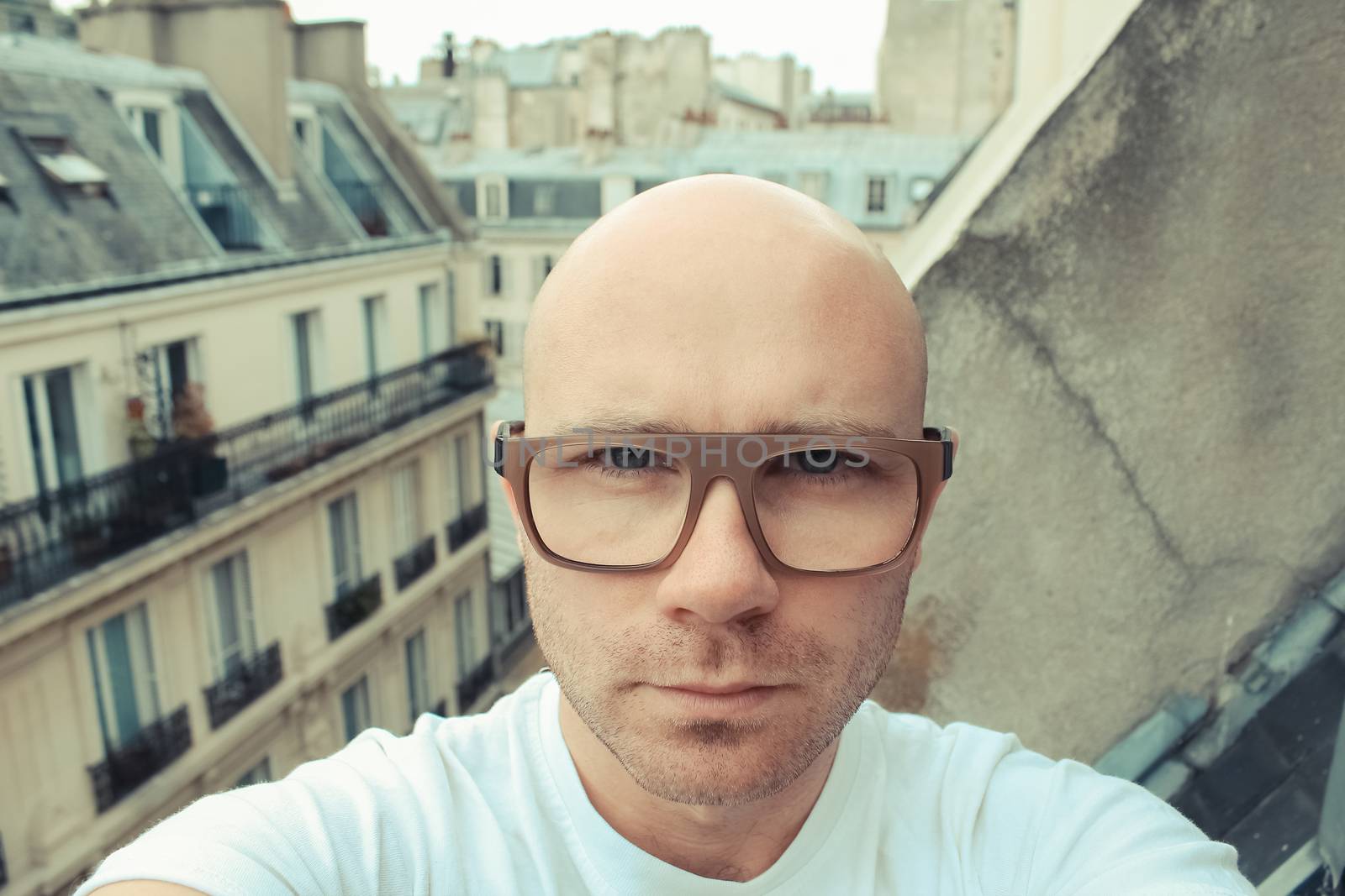 Caucasian bald man take selfie in Paris. old film toned