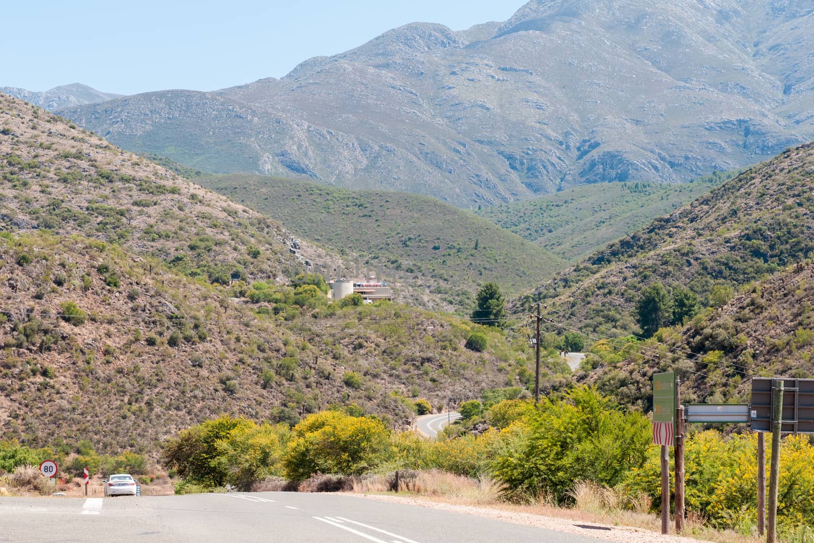 OUDTSHOORN, SOUTH AFRICA - JANUARY 2, 2015: Road to the Cango Caves. The building at the caves is visible. The caves are world famous for spectacular underground views