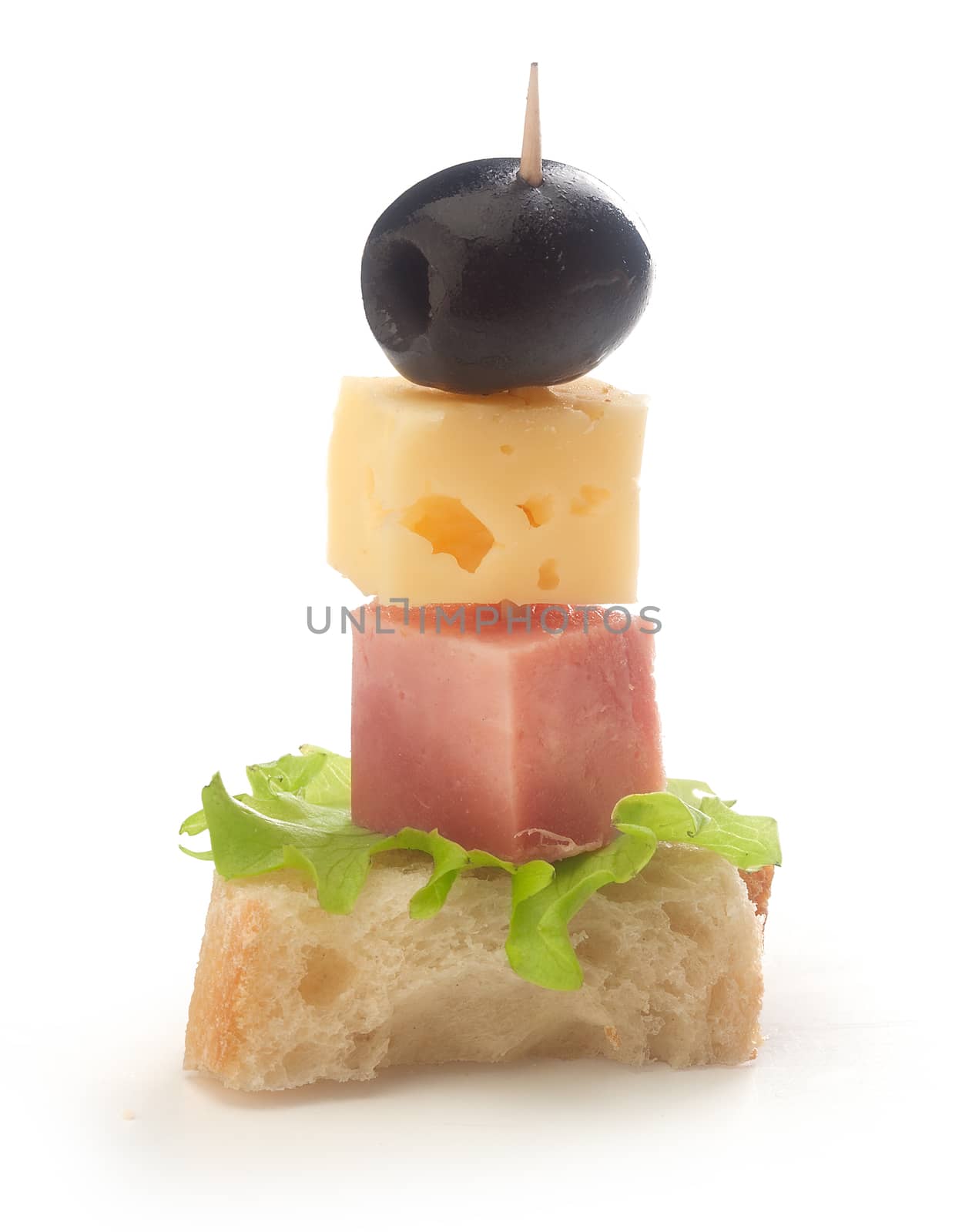 Isolated canape with ham, cheese and olive on the toothpick