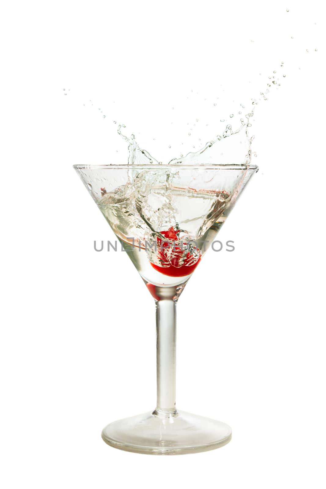 Splash of cherry in martini glass isolated on white background