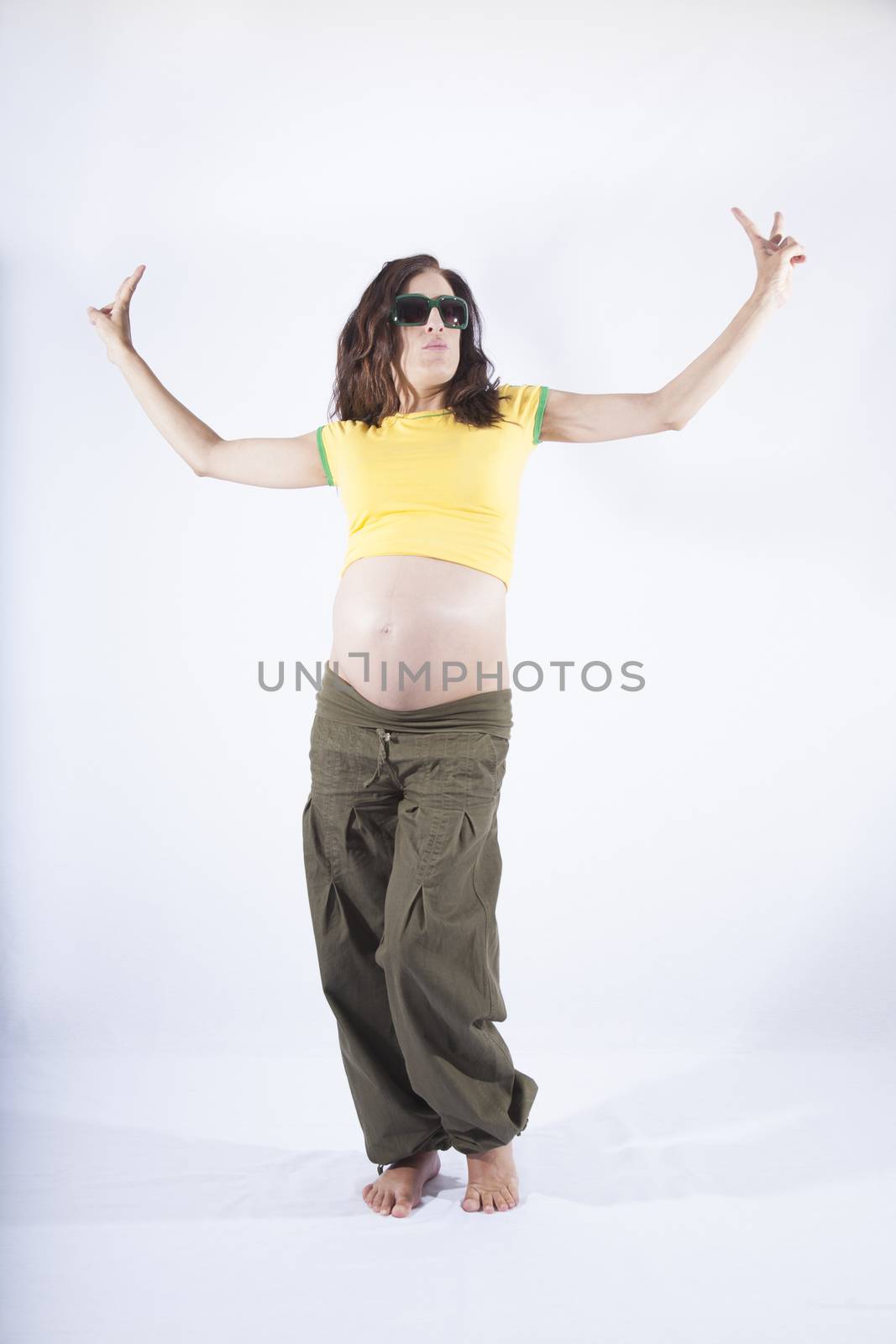 front of naked paunch eight month pregnant woman with brazilian colors shirt celebrating success winner isolated on over white background