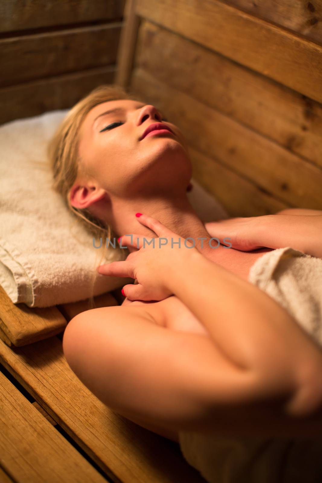 Young woman relaxing in a sauna, taking a break from her busy schedule, taking care of herself, enjoying the wellness benefits her job provides