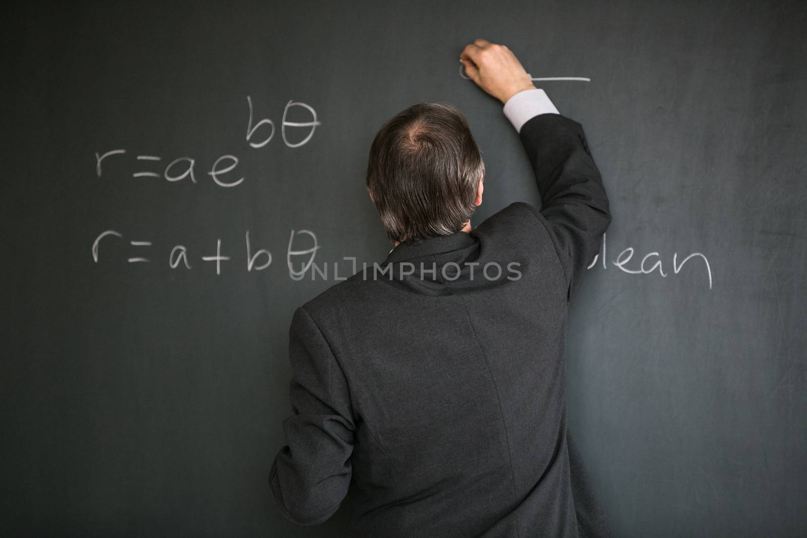 Senior male teacher teaching mathematics by viktor_cap