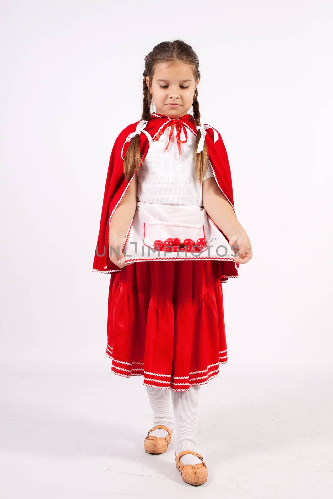 Little girl in costume red cap with cherries