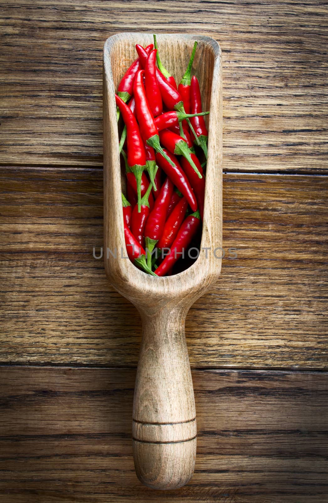 Red chili pepper in wooden scoop