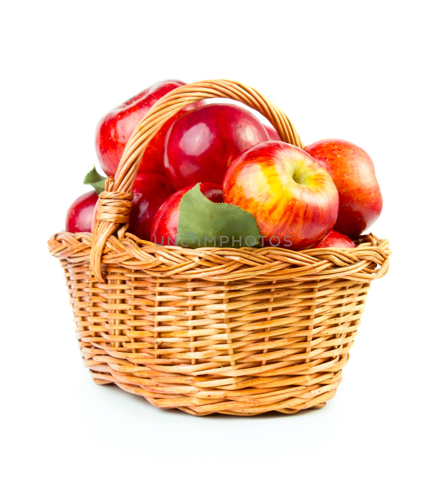Fresh red apples in basket isolated on white background