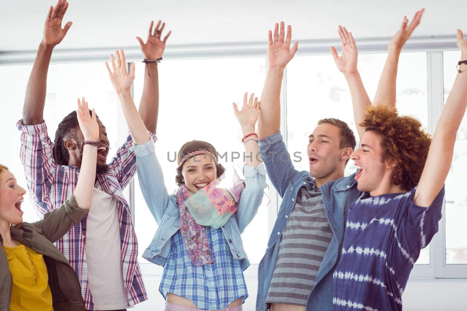 Fashion students cheering together by Wavebreakmedia