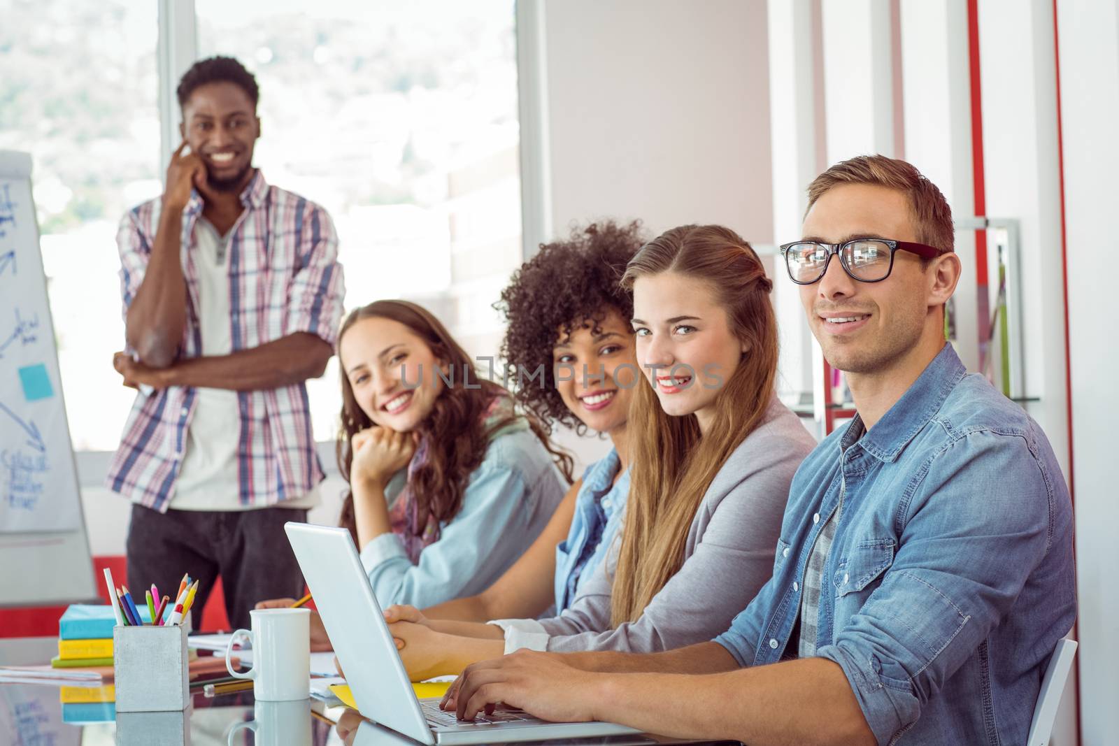 Fashion students smiling at camera at the college