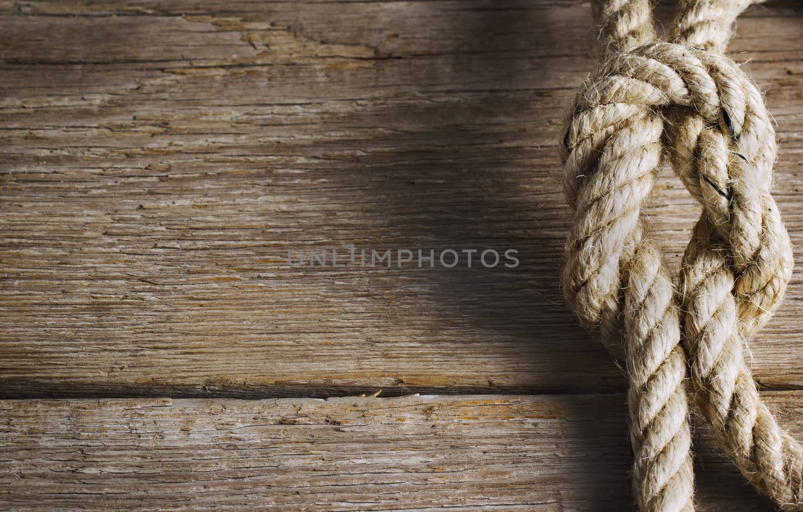 Old wood with rope knot