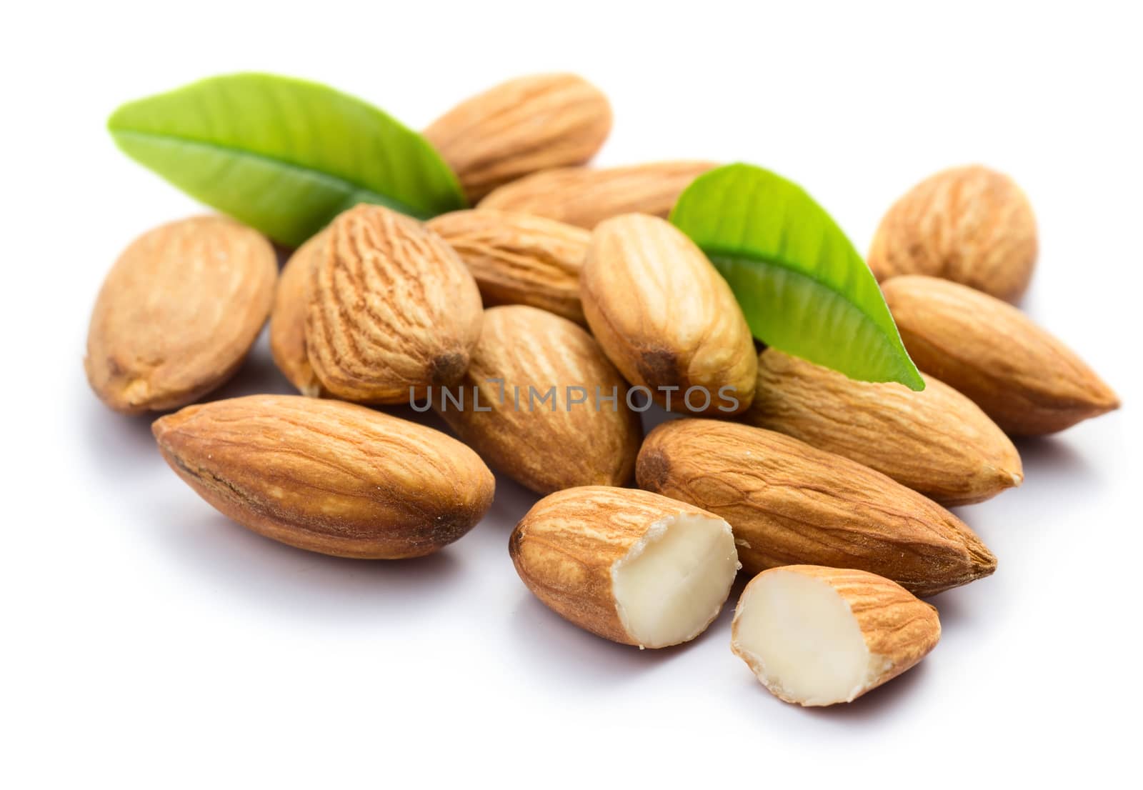 Almonds with leaves isolated on white background