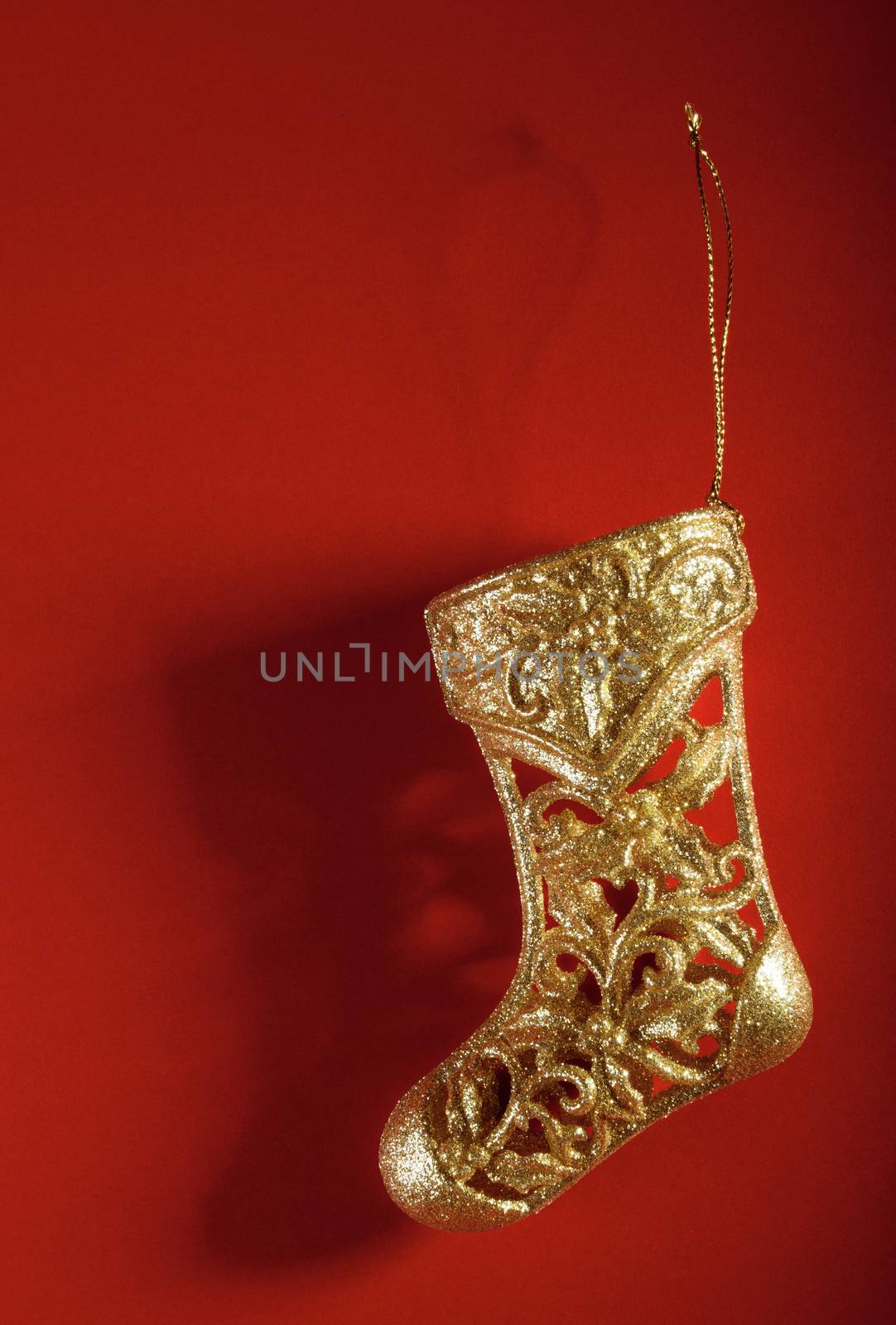 Christmas gold stocking on red background