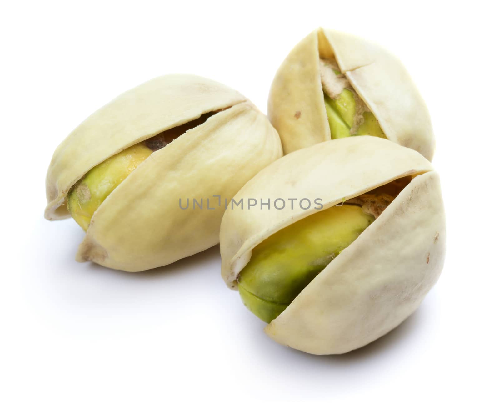 Three pistachio nuts isolated on white