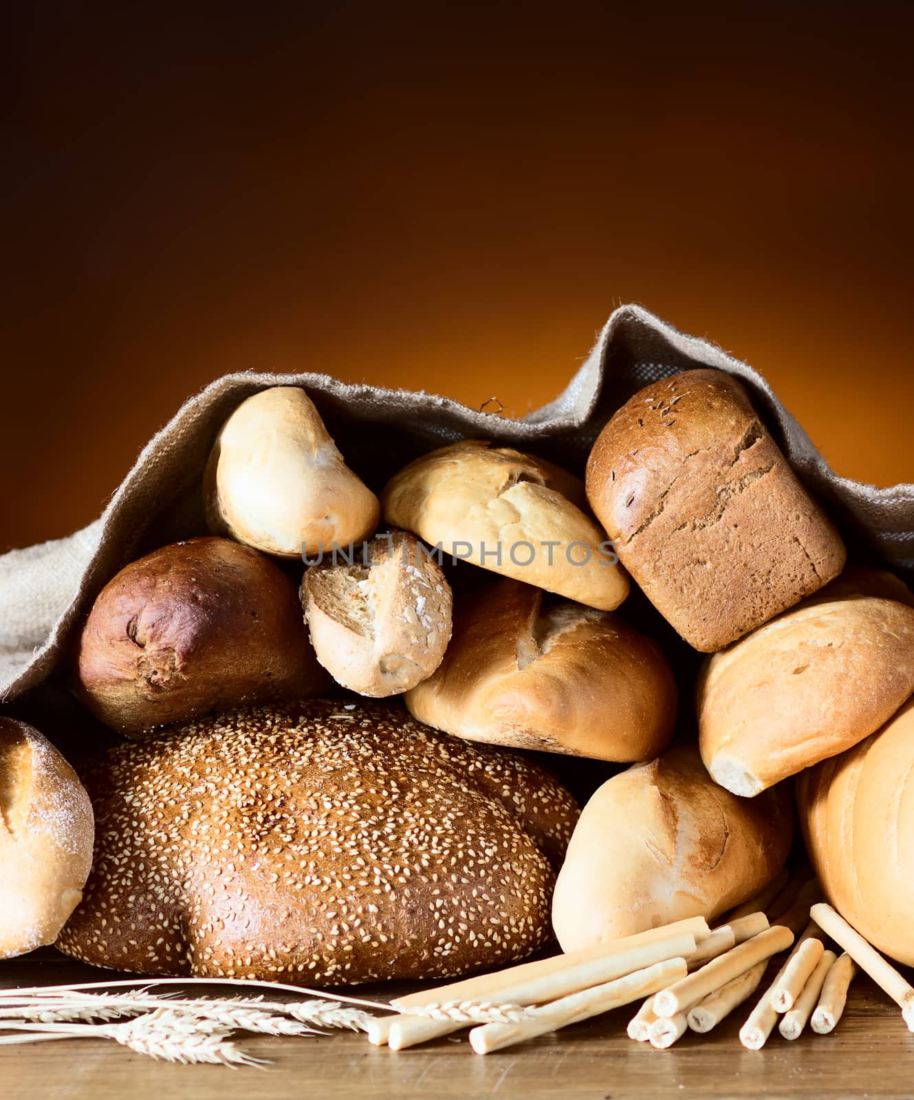 Bread assortment on fireplace background