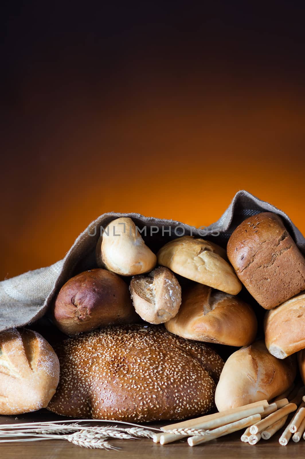 Bread assortment on fireplace background 