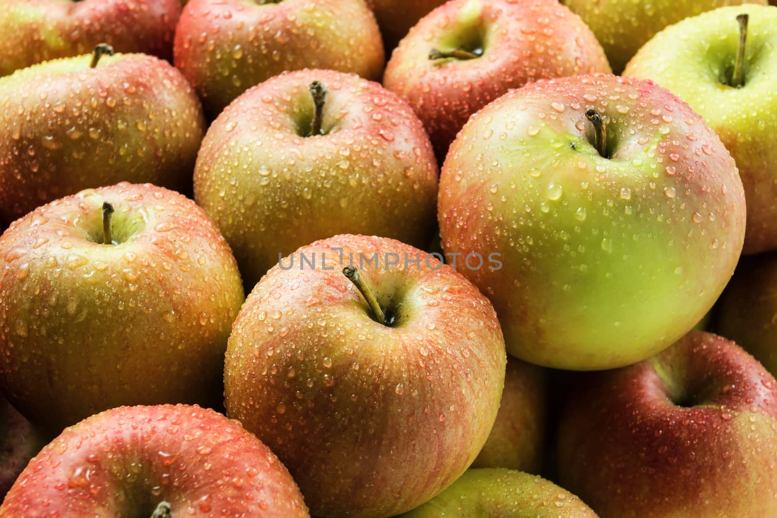 Apples with water drops, food background