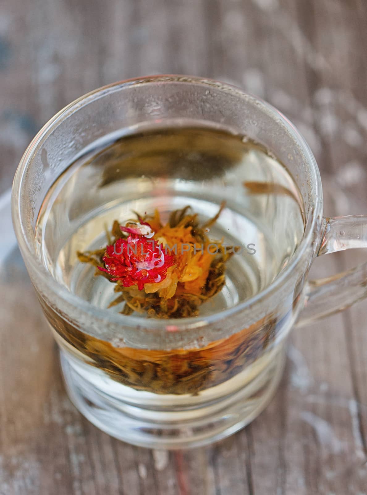 exotic green tea with flowers in glass cup