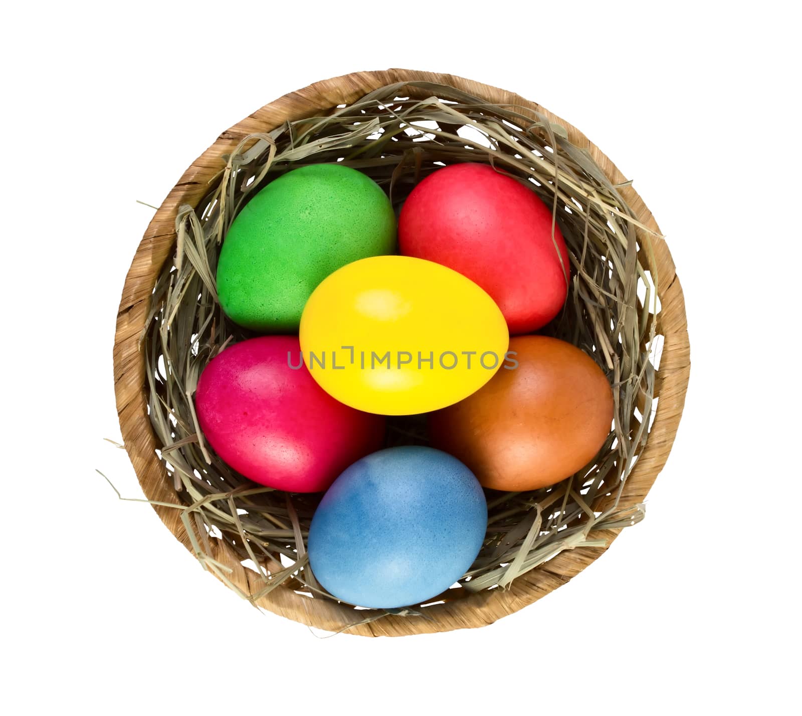 Easter eggs in nest basket isolated on white background. Top view