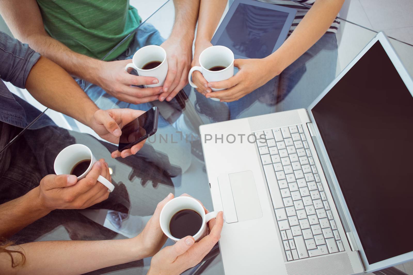 Fashion students holding cup of coffee at the college 