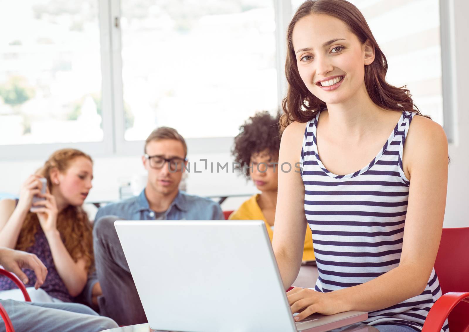 Fashion student using his laptop by Wavebreakmedia