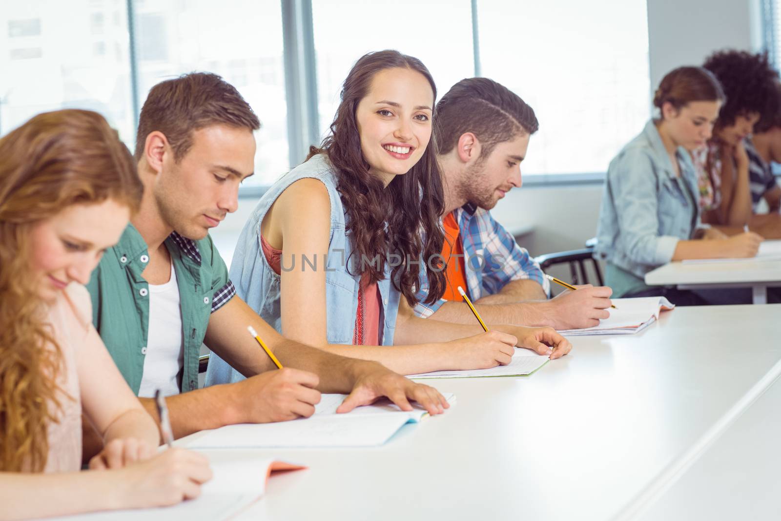 Fashion student smiling at camera in class by Wavebreakmedia