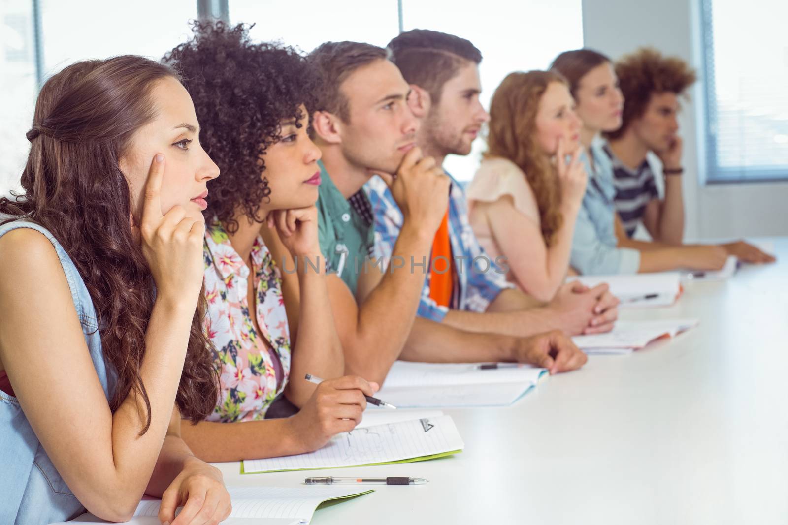 Fashion students being attentive in class by Wavebreakmedia