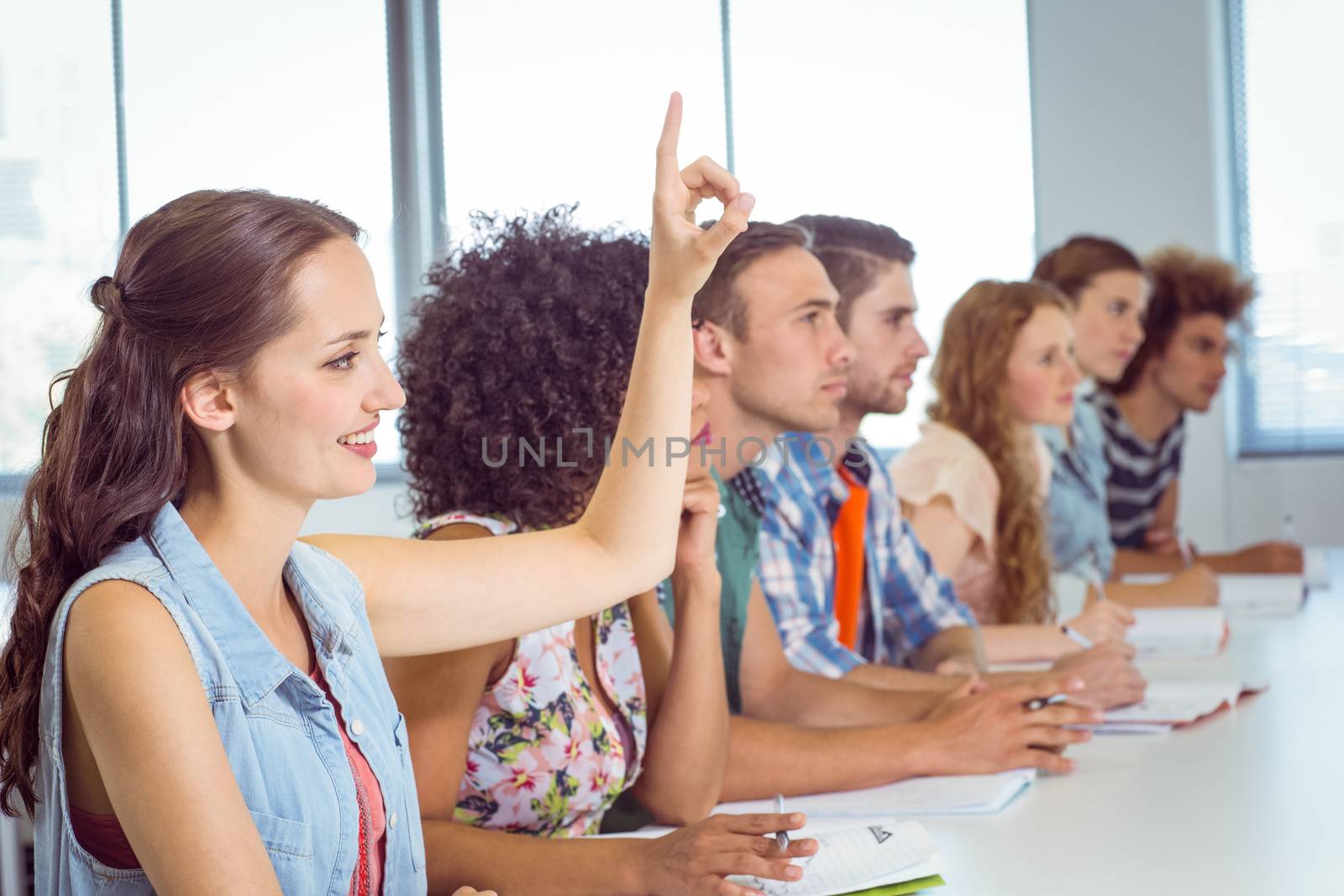 Fashion students being attentive in class by Wavebreakmedia