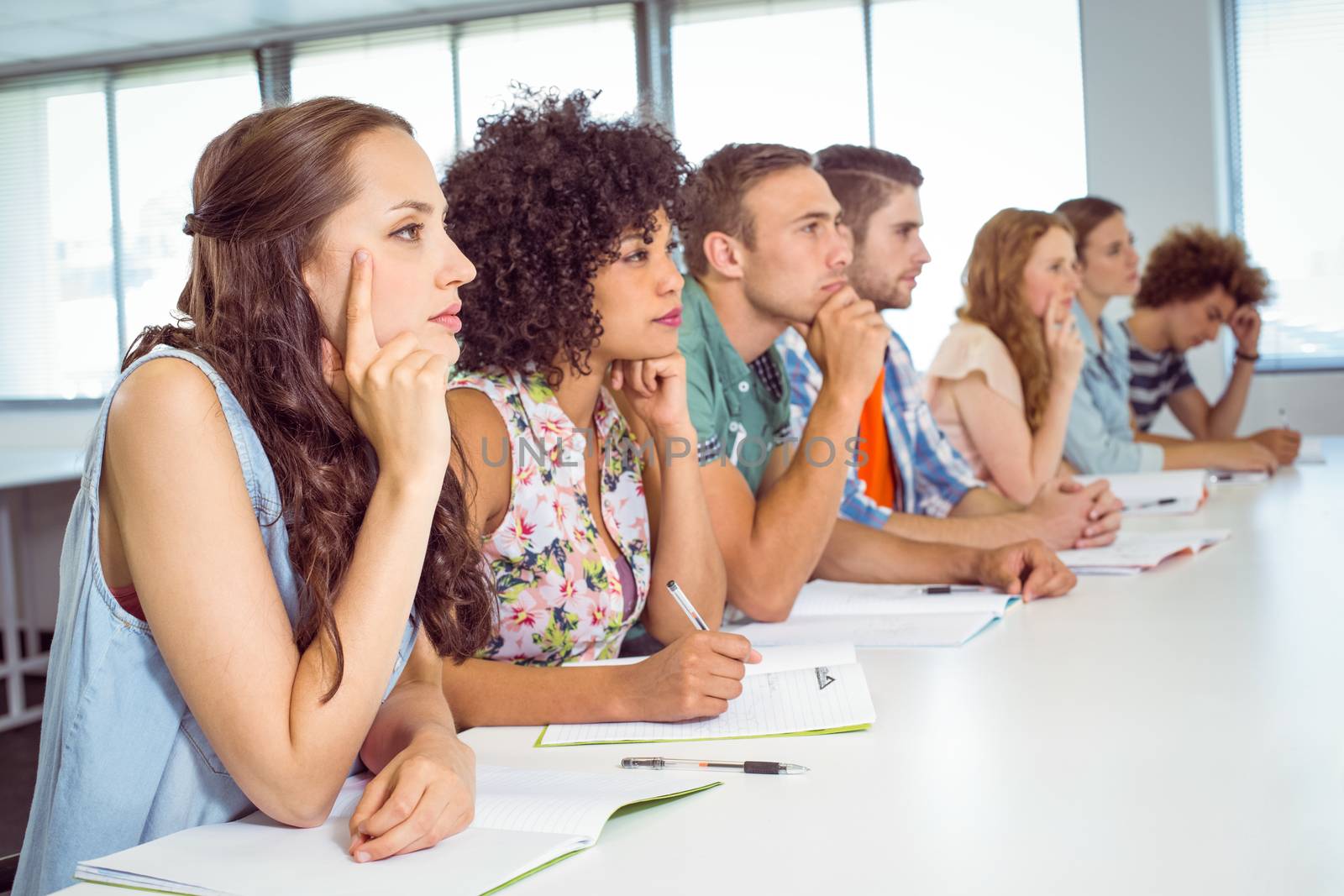 Fashion students being attentive in class at the college