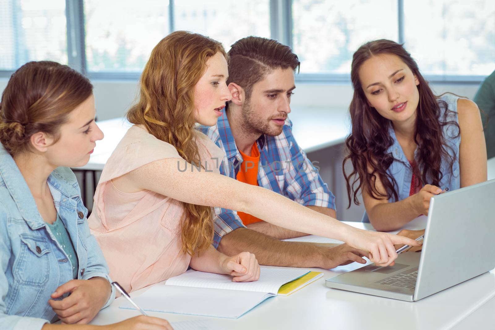 Fashion students looking at laptop at the college 