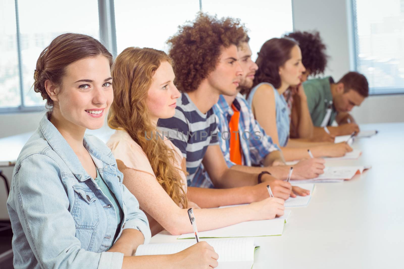 Fashion students taking notes in class by Wavebreakmedia