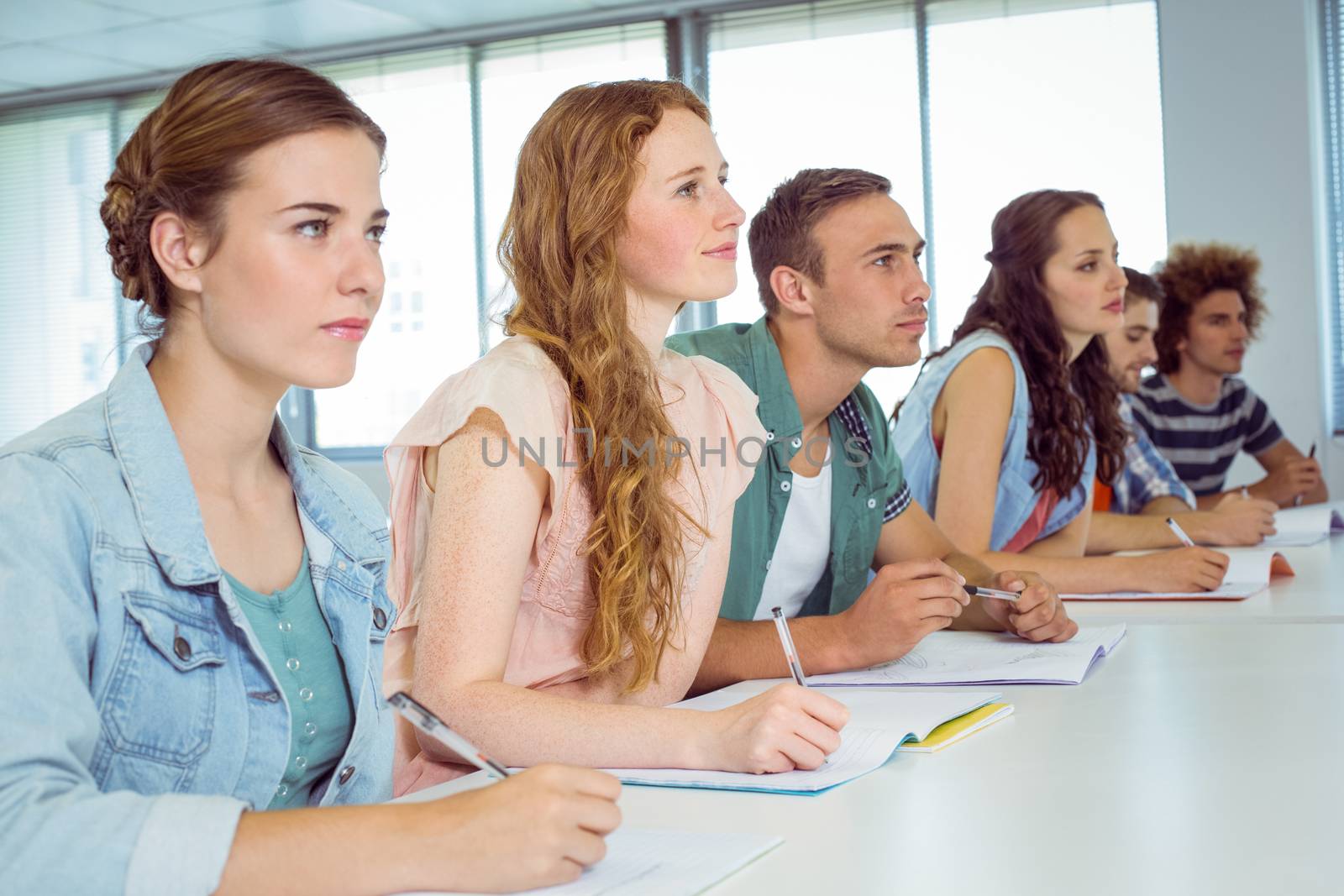 Fashion students taking notes in class at the college