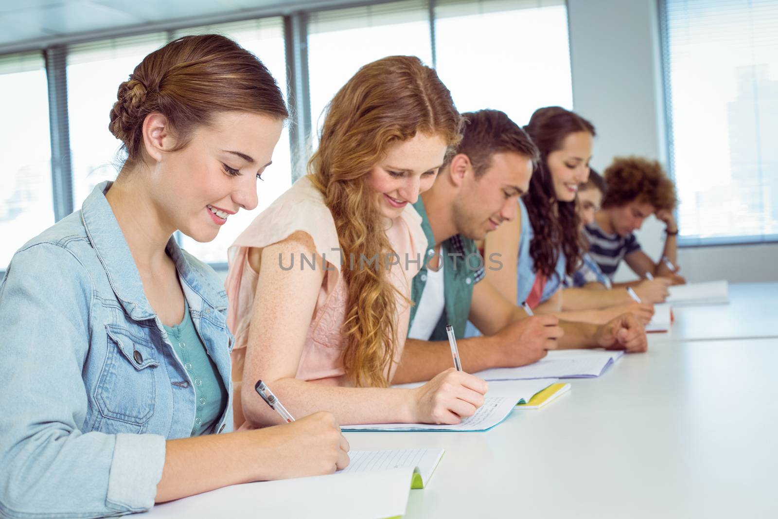 Fashion students taking notes in class by Wavebreakmedia