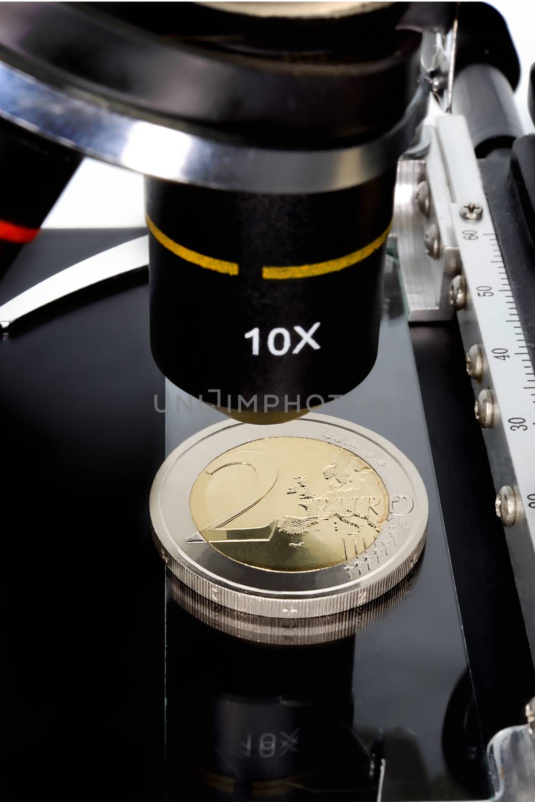Euro currency in check under the microscope.