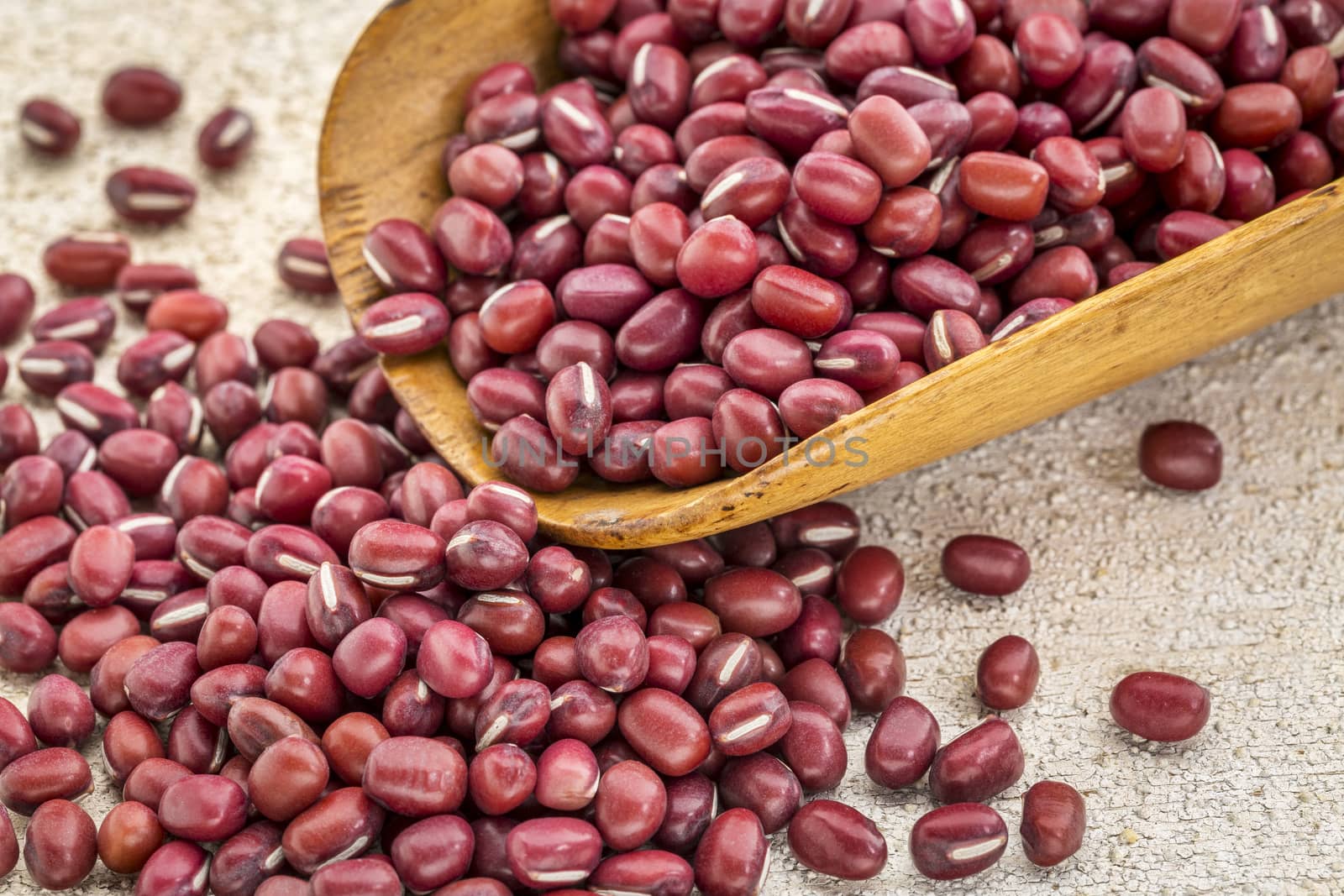 Japanese adzuki (aduki, azuki) beans on a wooden rustic scoop