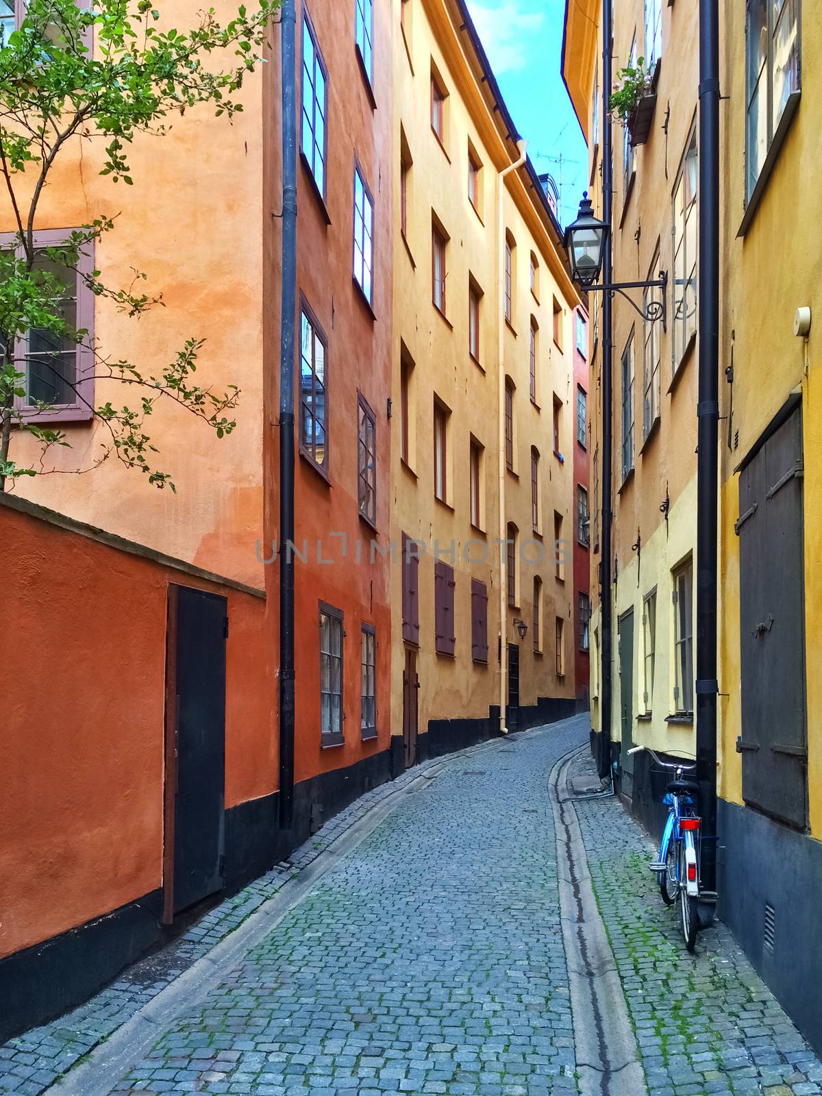 Narrow street with colorful buildings in Gamla Stan, historic center of Stockholm.