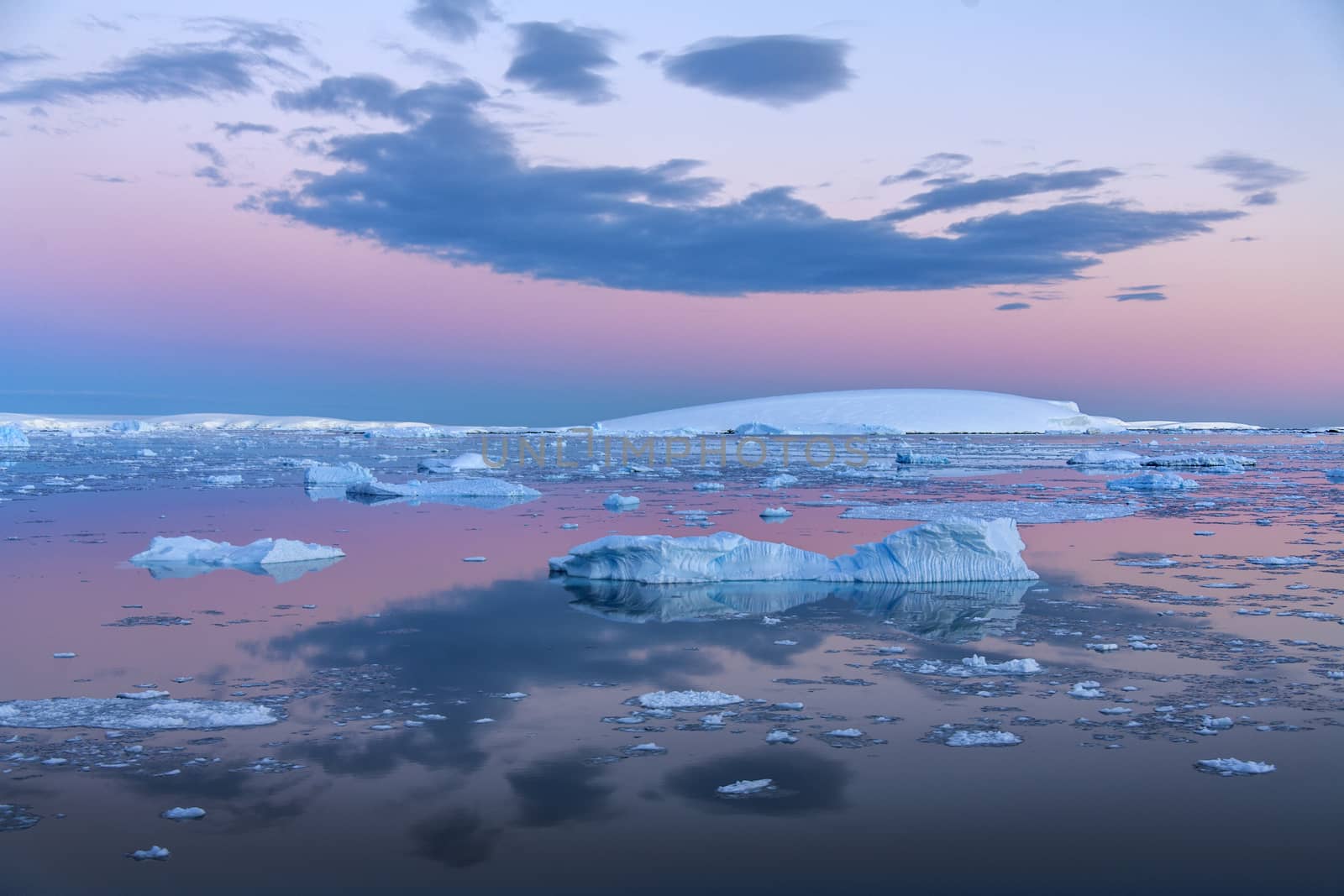 The Midnight sun over the icebergs in the Weddell Sea near the Antarctic Peninsula in Antarctica. 