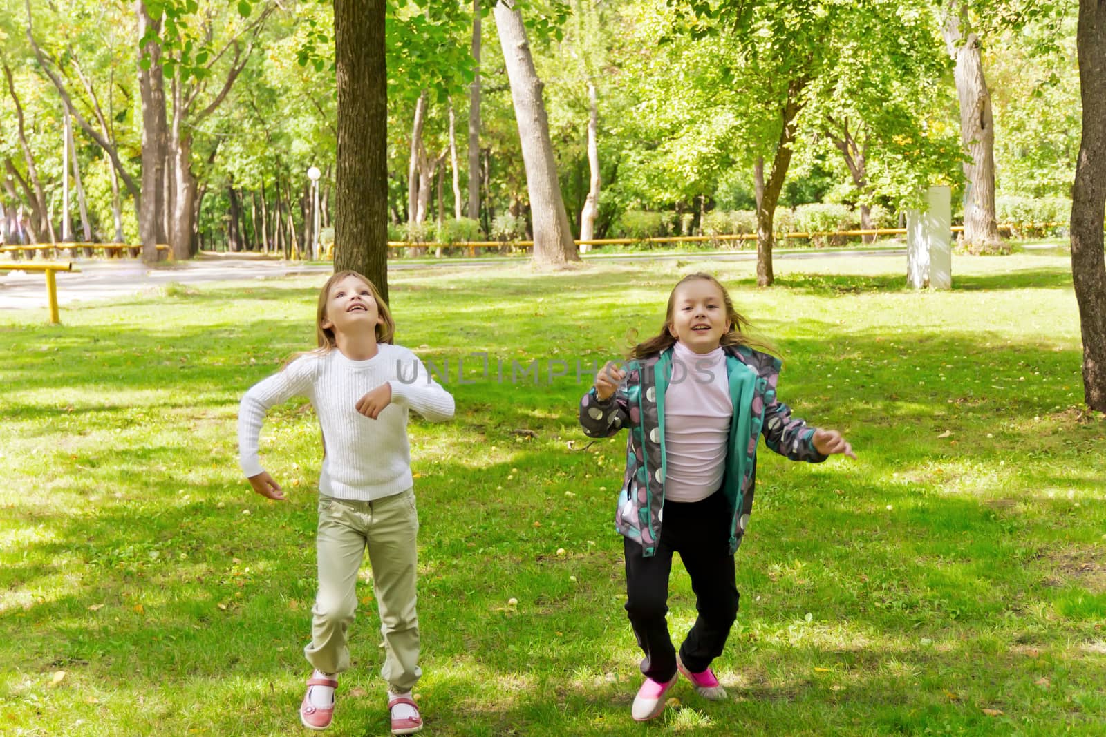 Photo of two running girls in summer