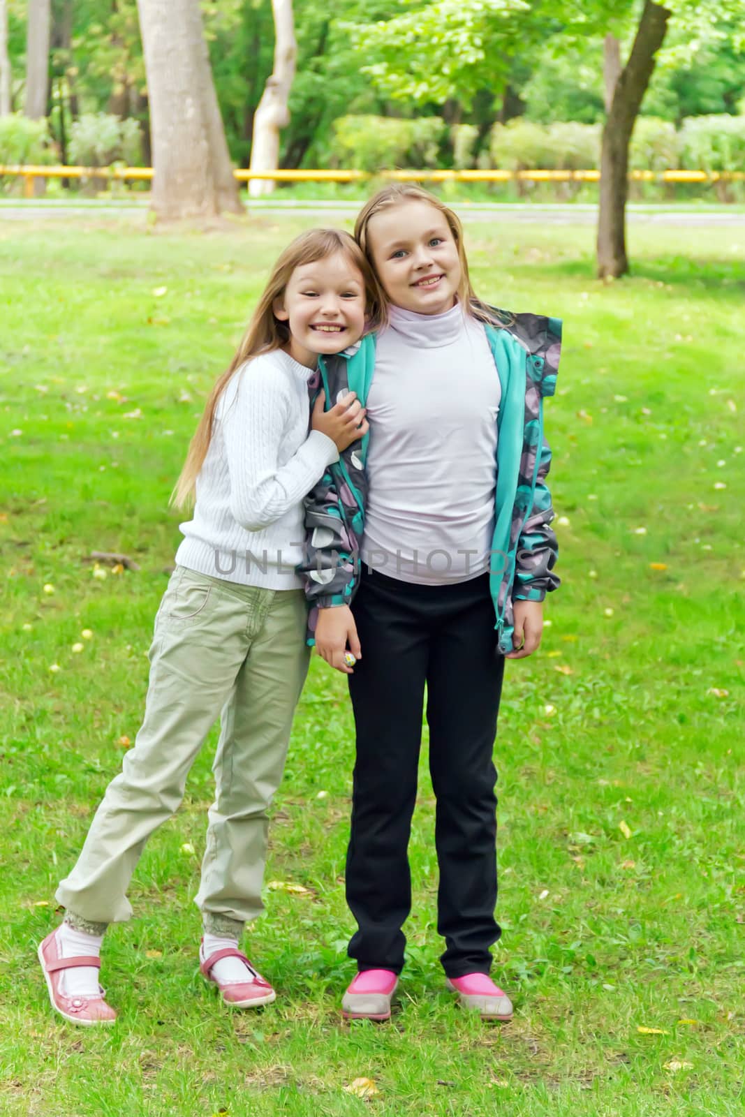 Photo of two playing girls in summer