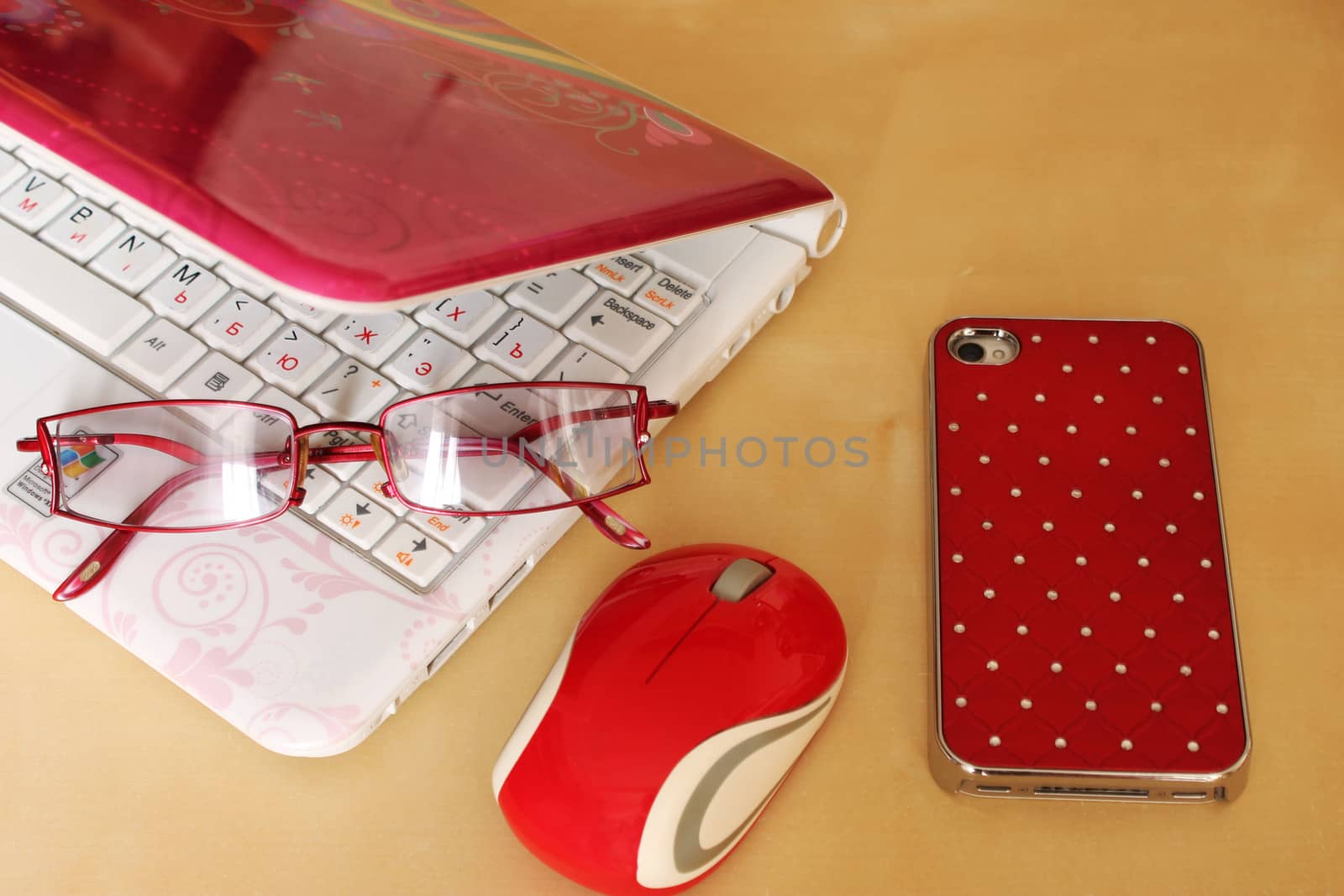 Computer, watches, sunglasses, mobile phone in red color scheme