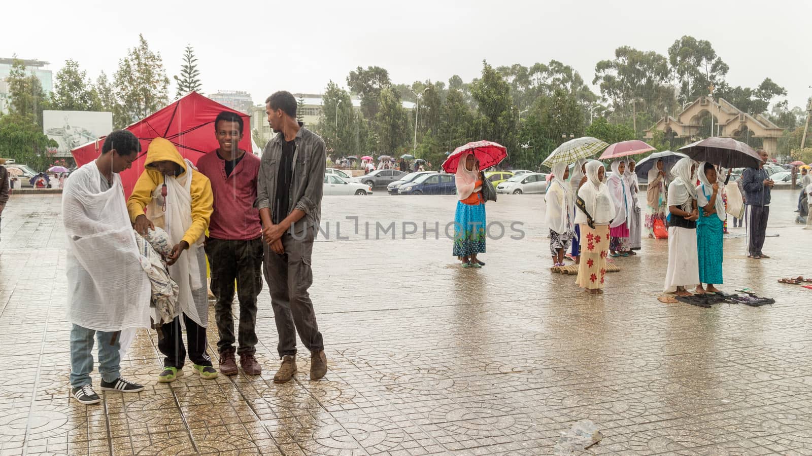 Addis Ababa: April 10: Devoted Ethiopian Orthodox followers stand undeterred by the pouring rain to observe Siklet, the crucifixion of Jesus Christ, at Bole Medhane Alem Church on April 10 ,2015 in Addis Ababa, Ethiopia