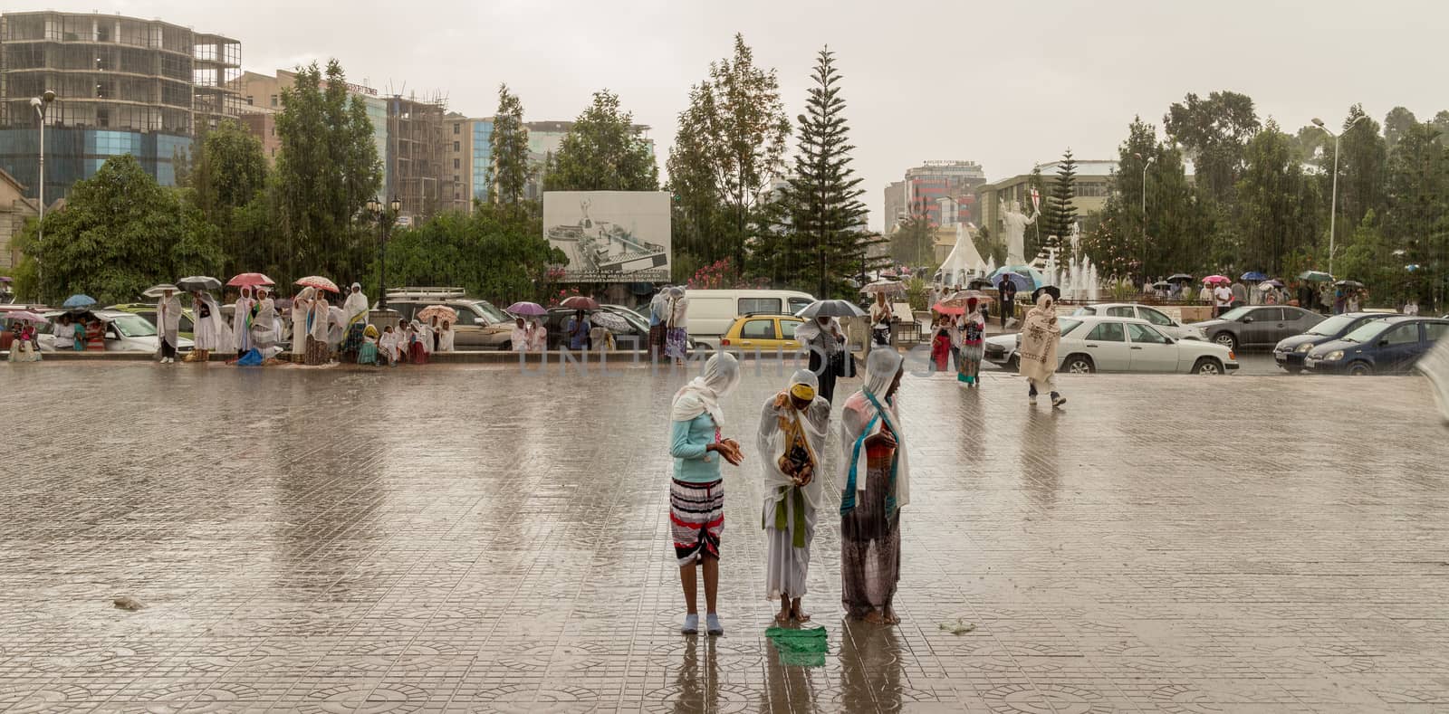 Addis Ababa: April 10: Devoted Ethiopian Orthodox followers stand undeterred by the pouring rain to observe Siklet, the crucifixion of Jesus Christ, at Bole Medhane Alem Church on April 10 ,2015 in Addis Ababa, Ethiopia