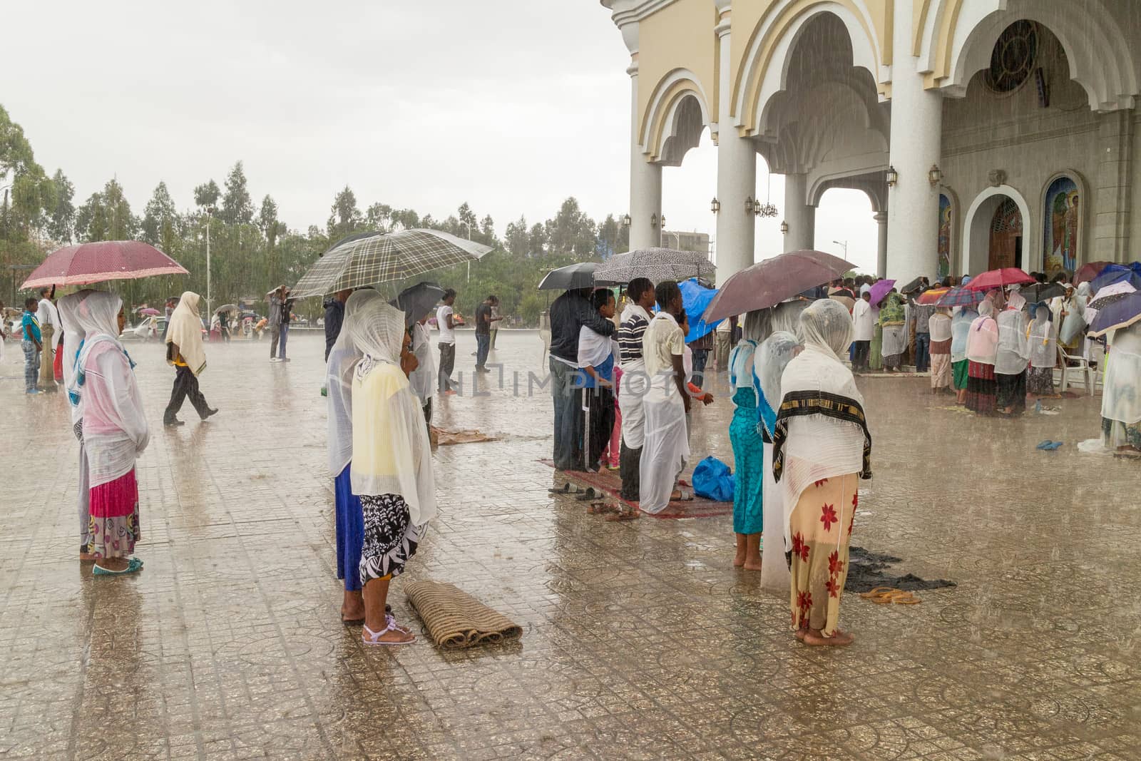 Addis Ababa: April 10: Devoted Ethiopian Orthodox followers stand undeterred by the pouring rain to observe Siklet, the crucifixion of Jesus Christ, at Bole Medhane Alem Church on April 10 ,2015 in Addis Ababa, Ethiopia